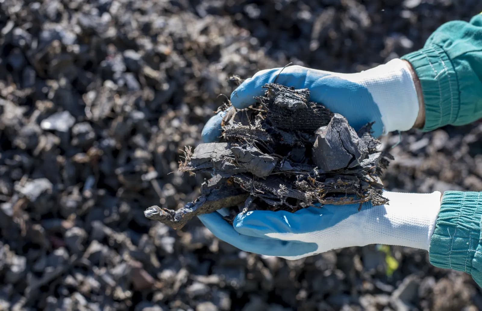 Materials: raw ore held in gloved hands